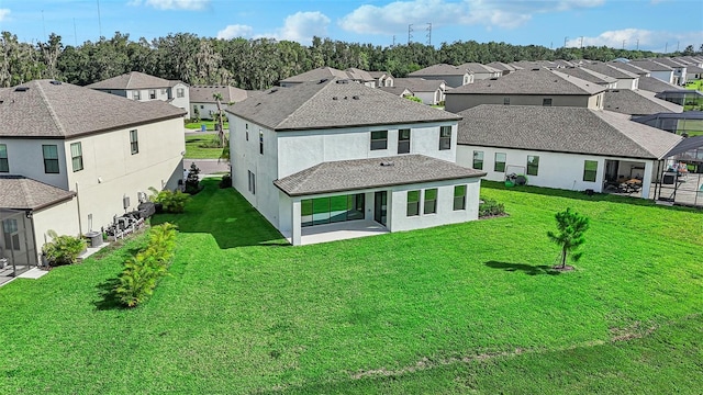 back of property featuring a patio and a lawn