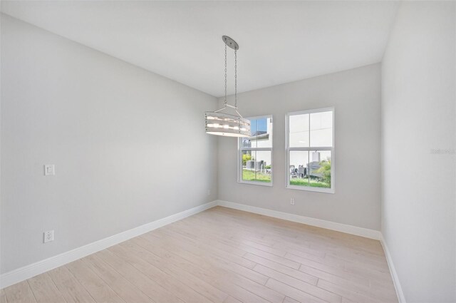 unfurnished room with light hardwood / wood-style floors