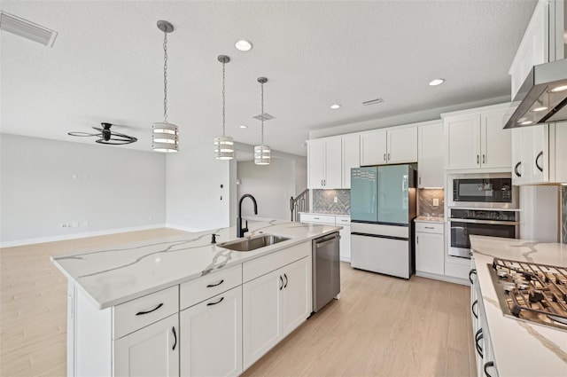 kitchen with sink, white cabinetry, stainless steel appliances, ventilation hood, and a center island with sink