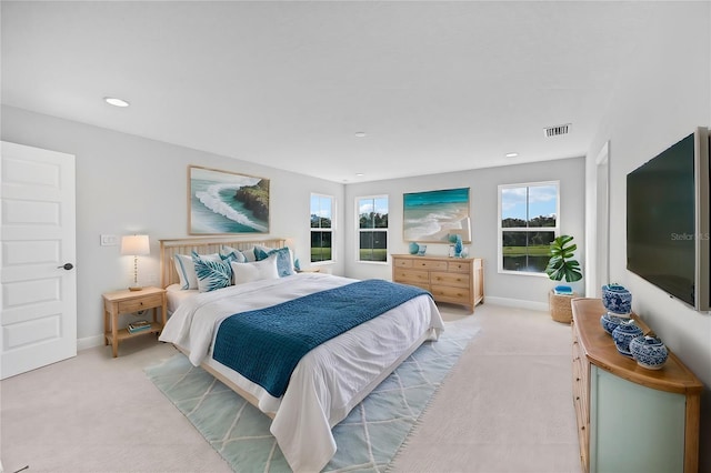 carpeted bedroom featuring multiple windows