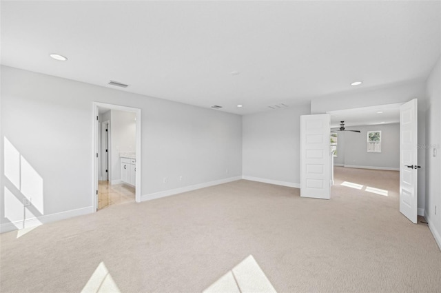 carpeted spare room with ceiling fan