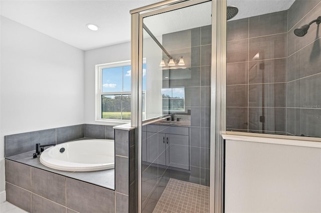 bathroom featuring vanity and separate shower and tub