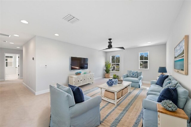 carpeted living room featuring ceiling fan