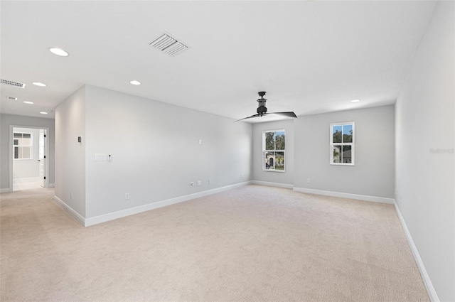 unfurnished room featuring ceiling fan and light carpet