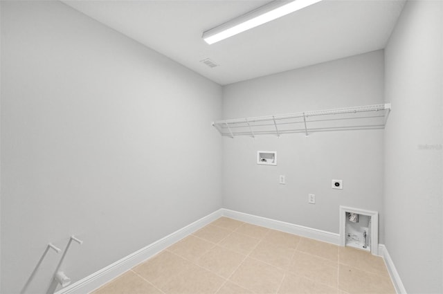 laundry area with light tile patterned flooring, hookup for a washing machine, and electric dryer hookup