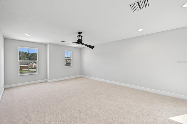 carpeted empty room featuring ceiling fan