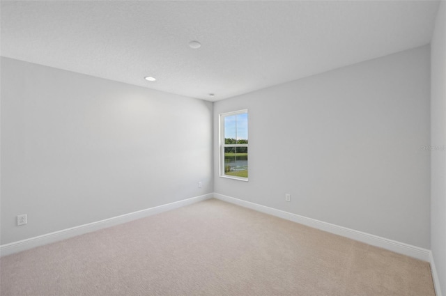 empty room with light colored carpet