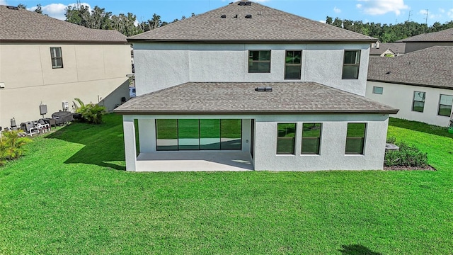 back of property featuring a yard and a patio