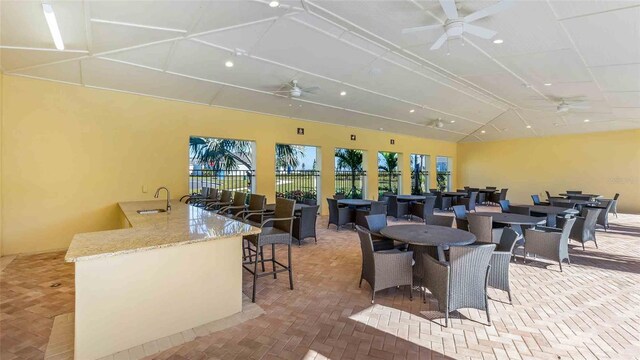 18316 Fattoria Ter, Lakewood Ranch, FL 34211 - dining area with brick floor, vaulted ceiling, and ceiling fan