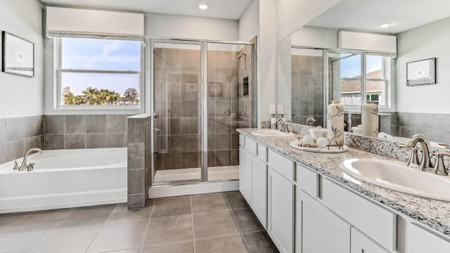 bathroom with tile patterned flooring, vanity, and independent shower and bath