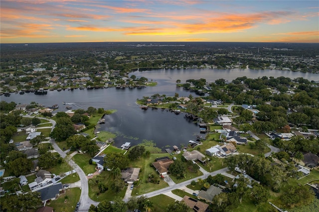 aerial view at dusk with a water view