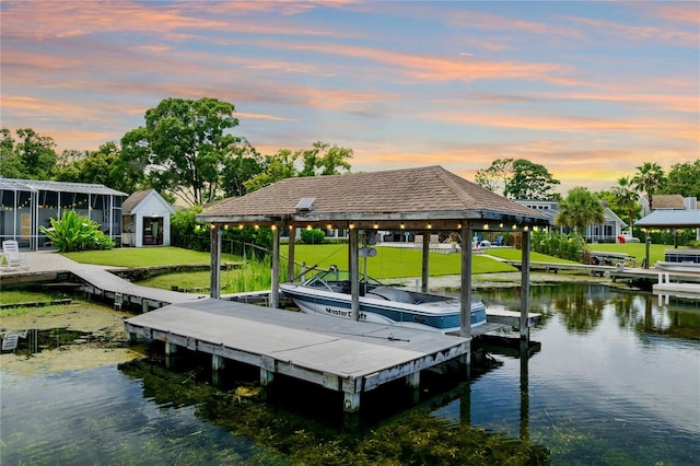 view of dock featuring a water view and a lawn