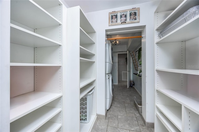 walk in closet featuring stacked washer / drying machine