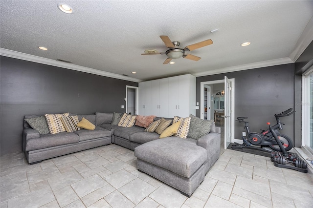 living room with ceiling fan, ornamental molding, and a textured ceiling