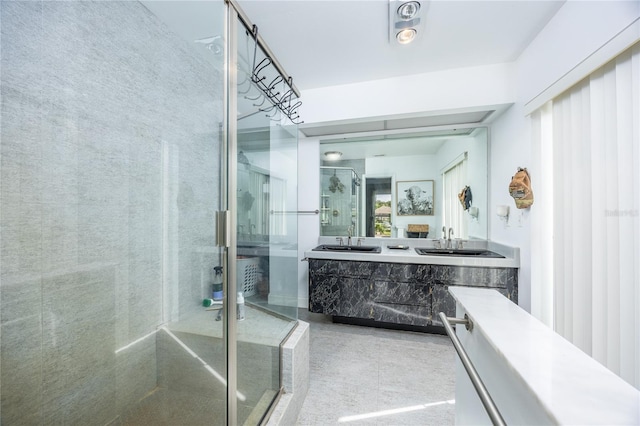 bathroom with vanity and a shower with shower door