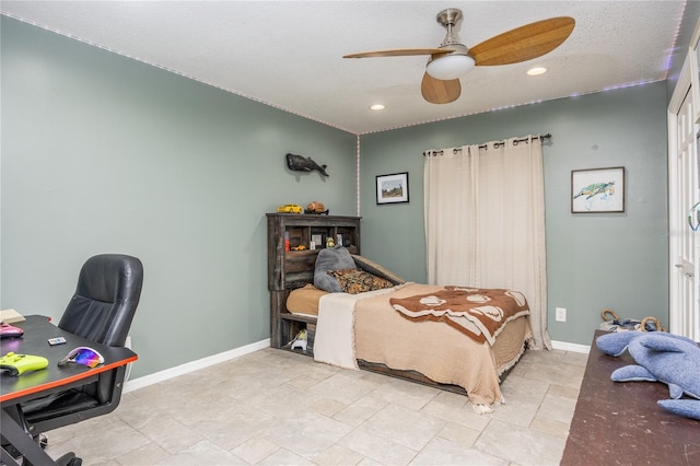 tiled bedroom featuring ceiling fan and a textured ceiling