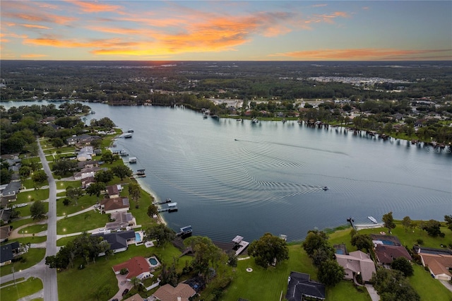 aerial view at dusk with a water view