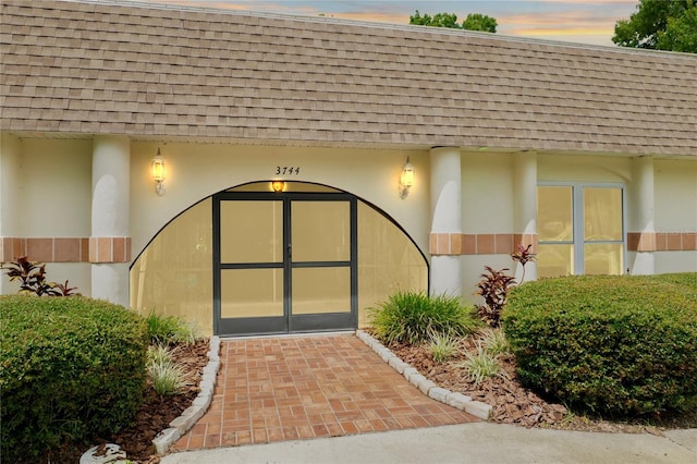 view of exterior entry at dusk