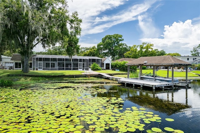 view of dock featuring a yard, a water view, and boat lift