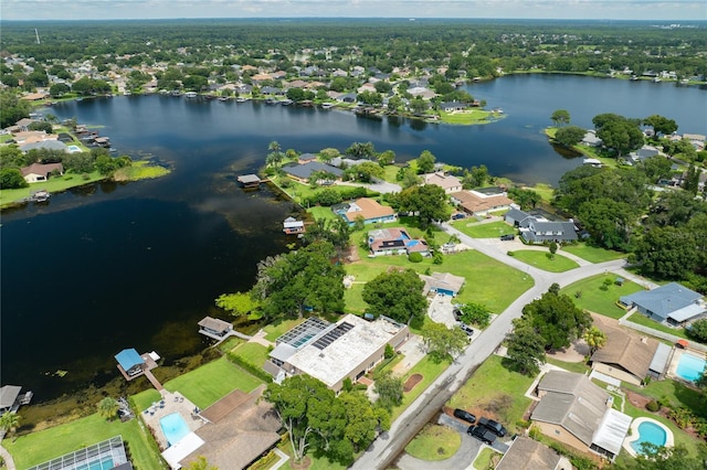 drone / aerial view featuring a residential view and a water view