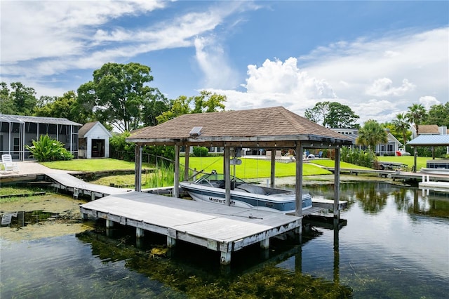 dock area featuring a water view and a yard