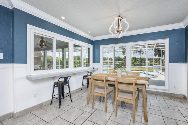 sunroom / solarium featuring an inviting chandelier