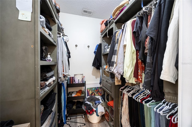 spacious closet featuring visible vents and wood finished floors