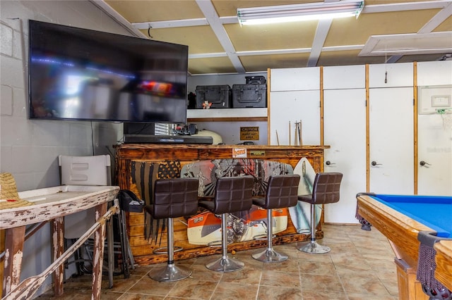 interior space with concrete block wall and pool table