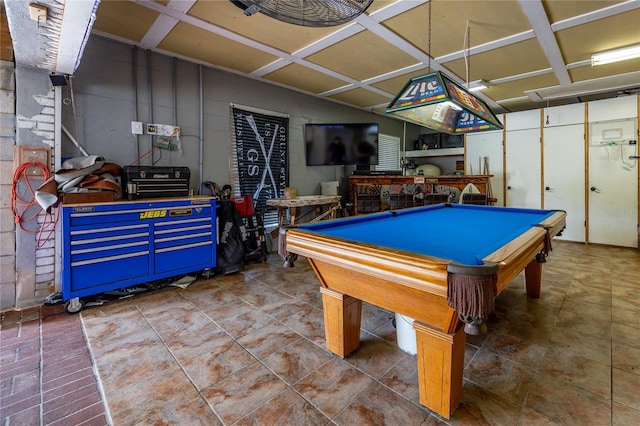 game room with concrete block wall and pool table