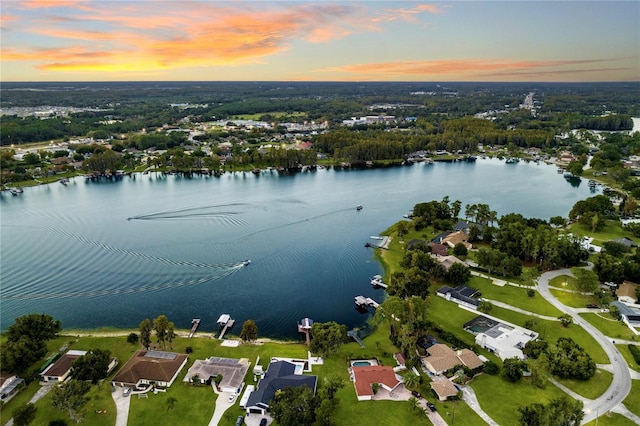 aerial view at dusk with a water view