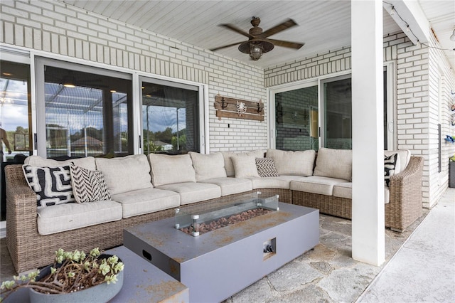 view of patio with ceiling fan and an outdoor living space with a fire pit