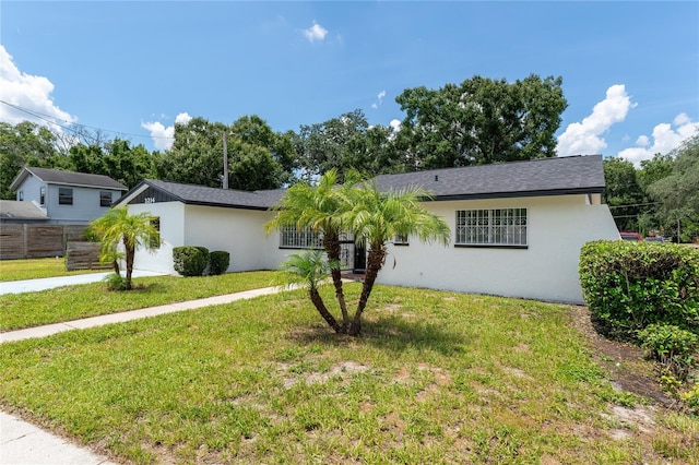 ranch-style home featuring a front yard