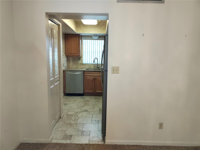 corridor with sink and light tile patterned floors