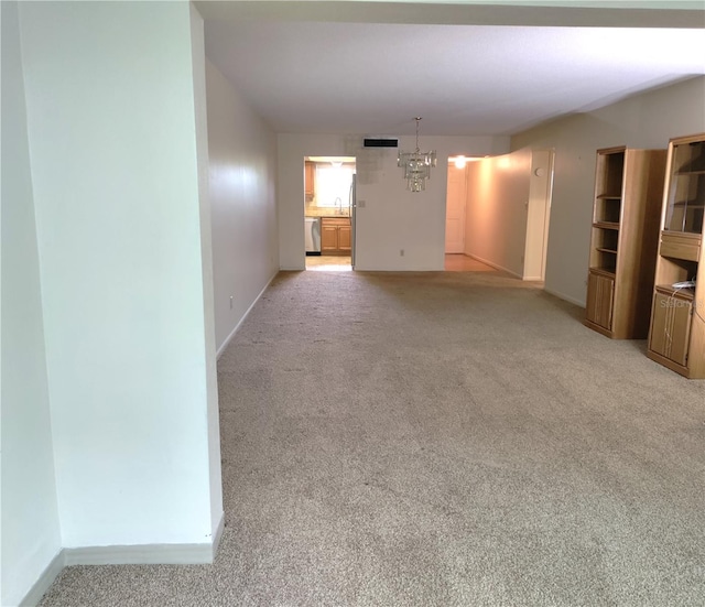 interior space with sink, an inviting chandelier, and light colored carpet