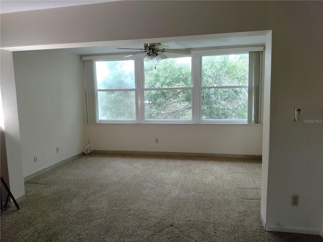 unfurnished room featuring carpet flooring and ceiling fan