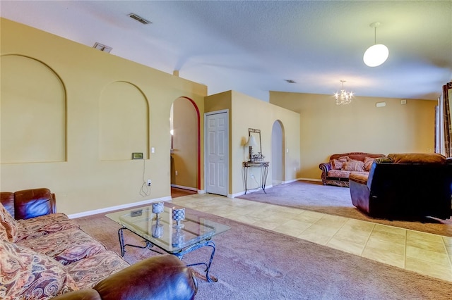 tiled living room featuring lofted ceiling and a chandelier