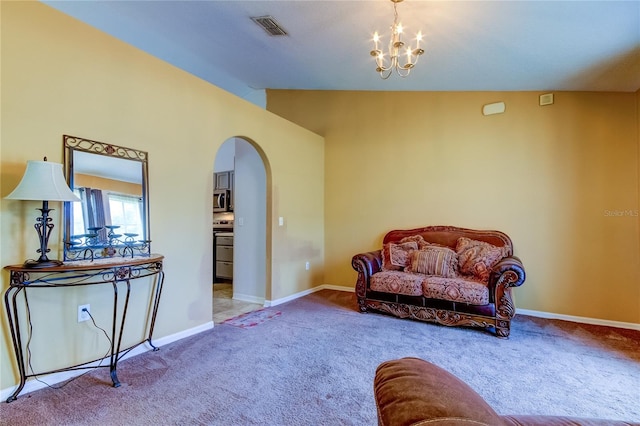 carpeted living room featuring lofted ceiling and a chandelier