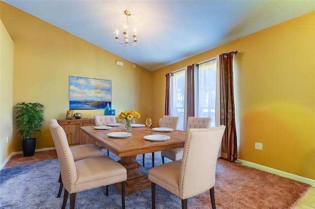 dining area featuring vaulted ceiling and a chandelier