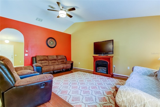 living room with wood-type flooring, ceiling fan, and vaulted ceiling