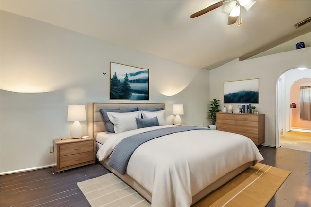 bedroom with dark wood-type flooring, vaulted ceiling, and ceiling fan