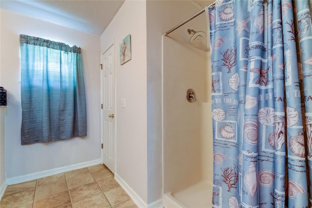 bathroom featuring curtained shower and tile patterned flooring