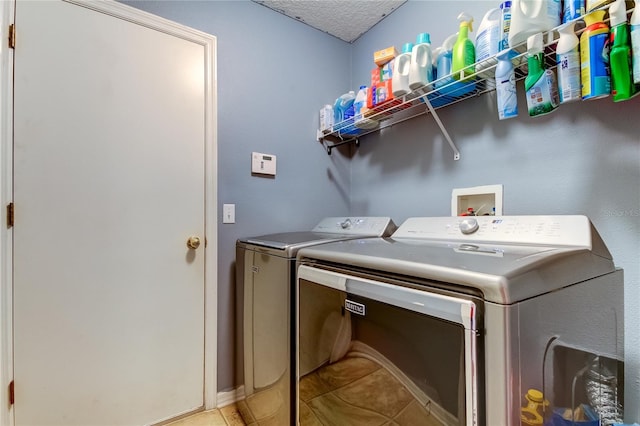 washroom featuring light tile patterned floors, a textured ceiling, and separate washer and dryer