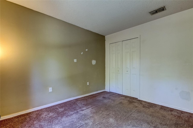 unfurnished bedroom with a closet and carpet floors