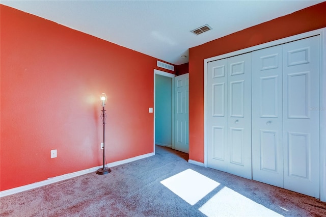 unfurnished bedroom with a closet and carpet floors