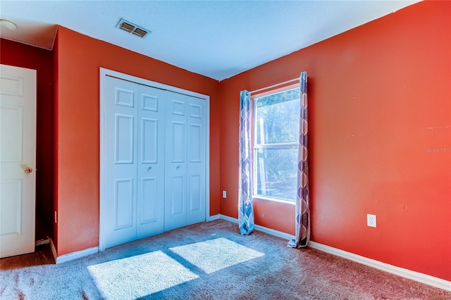 unfurnished bedroom with a closet and carpet