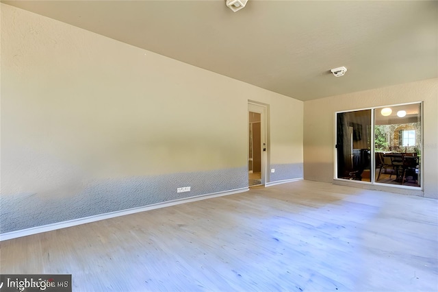 spare room featuring hardwood / wood-style flooring