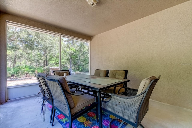 dining space with a textured ceiling and concrete floors