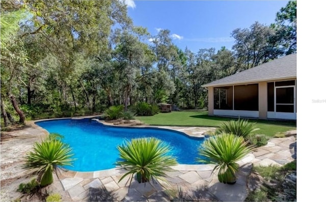 view of pool featuring a yard