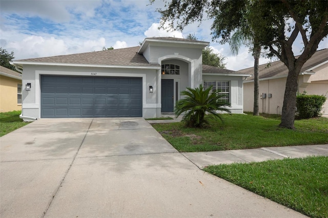 view of front of property featuring a front lawn and a garage