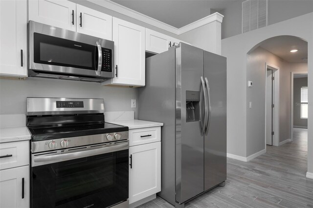 kitchen featuring light hardwood / wood-style flooring, stainless steel appliances, and white cabinets